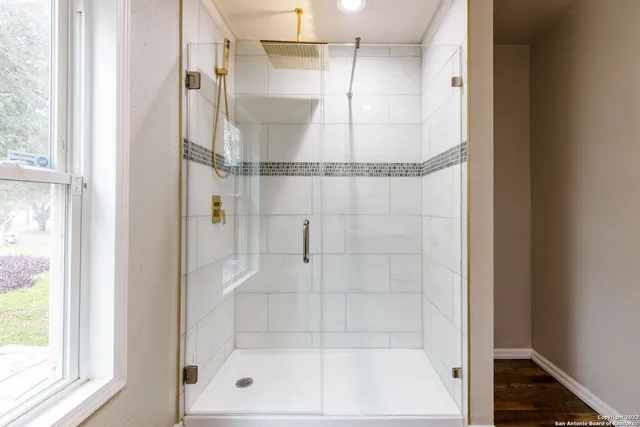 a bathroom with a glass shower door