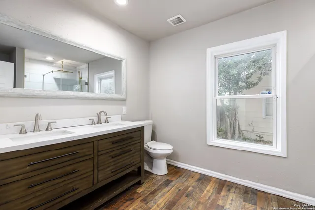 a bathroom with a toilet sink and a window