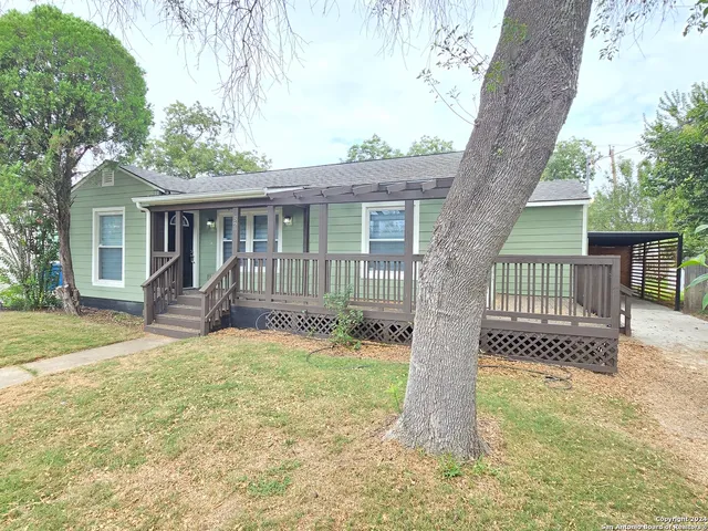 a view of a house with a tree in the yard