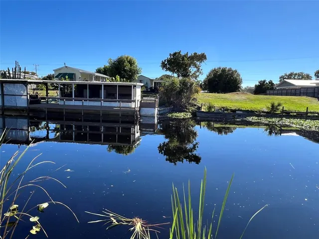 a balcony with furniture and a lake view