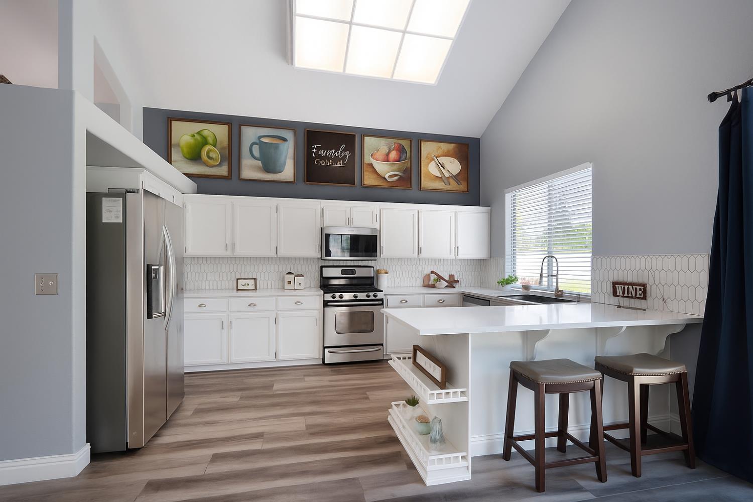 9567 Diamond Point Lane Elk Grove, CA 95758 - Photo 1 of 1 a kitchen with stainless steel appliances granite countertop a refrigerator a stove a sink dishwasher and white cabinets with wooden floor