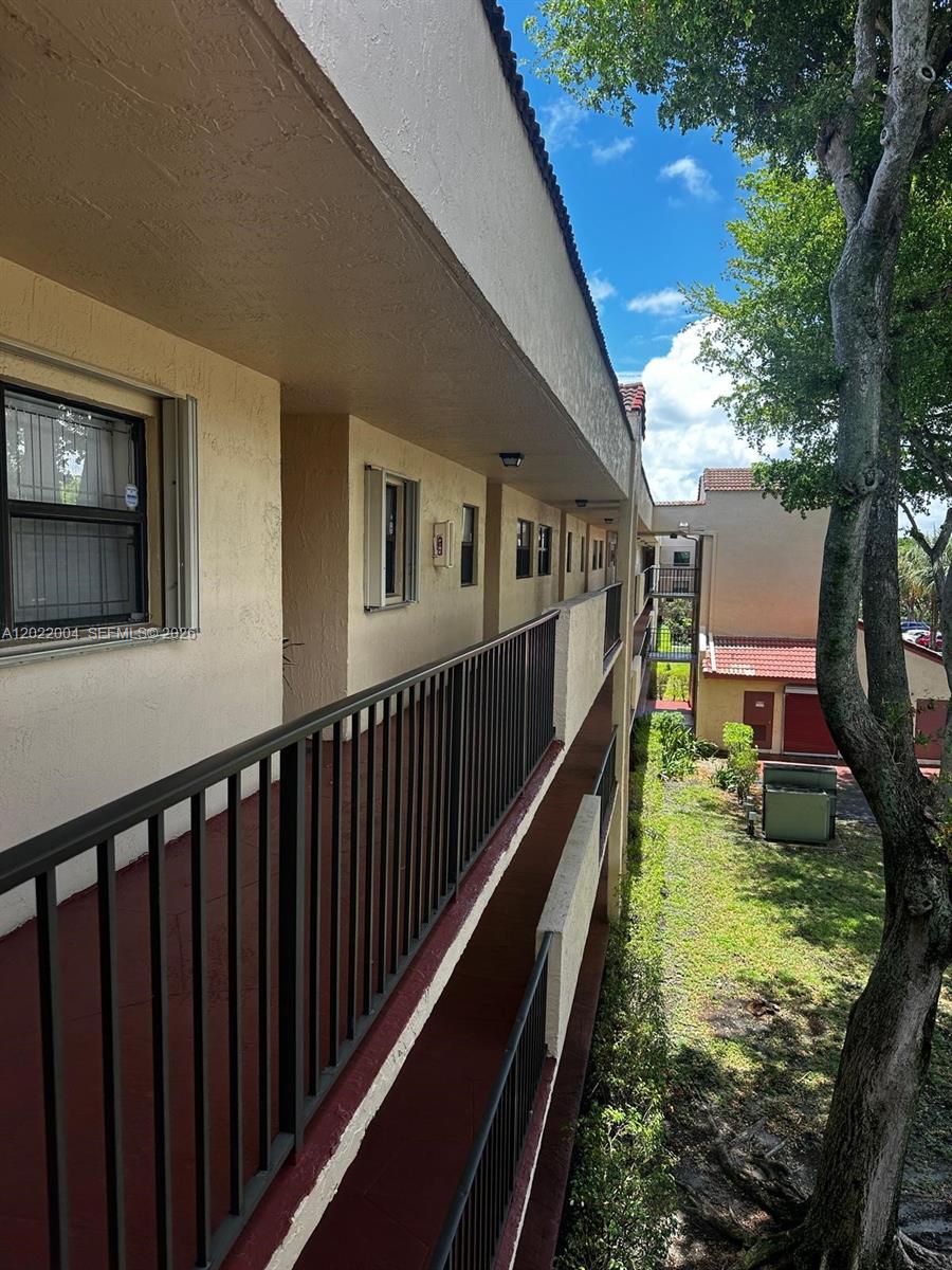 3400 Foxcroft Road, Unit 301 Miramar, FL 33025 - Photo 69 of 72 a view of balcony with wooden floor and seating space