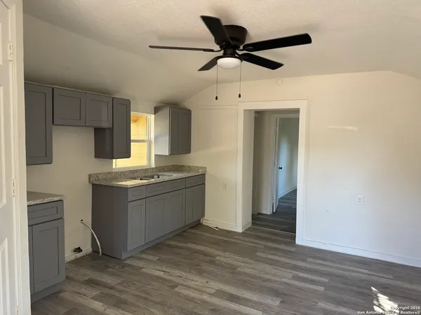 a kitchen with a refrigerator and a sink