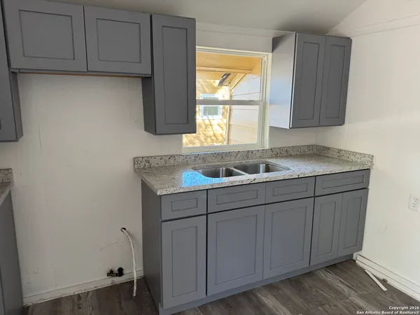 a sink with wooden cabinets