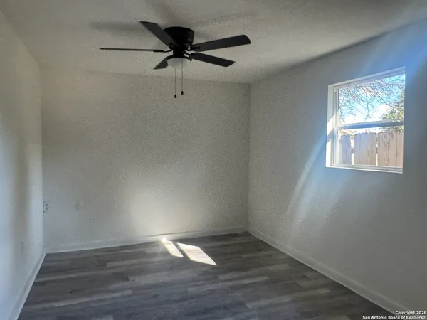 a view of a room with wooden floor and windows