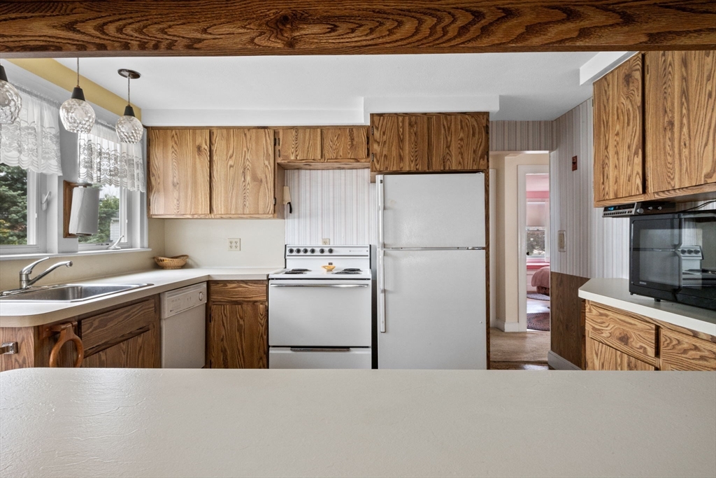 10 Shepard Street Marblehead, MA 01945 - Photo 12 of 42 a kitchen with stainless steel appliances a refrigerator sink and cabinets