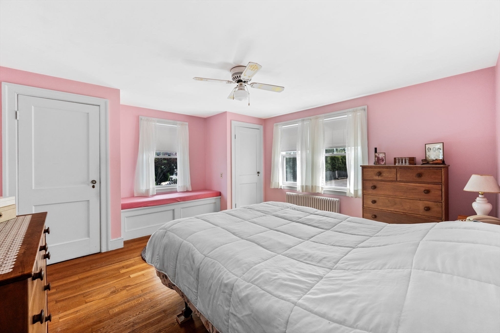10 Shepard Street Marblehead, MA 01945 - Photo 23 of 42 a bedroom with a large bed and a chandelier