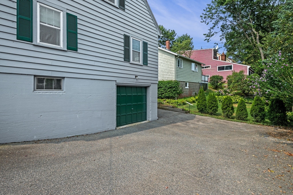 10 Shepard Street Marblehead, MA 01945 - Photo 7 of 42 a front view of a house with a yard and garage