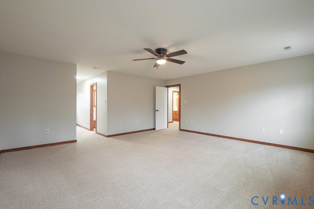 11030 Golden Leaf Road Chester, VA 23831 - Photo 25 of 50 Master bedroom with light carpet and a ceiling fan