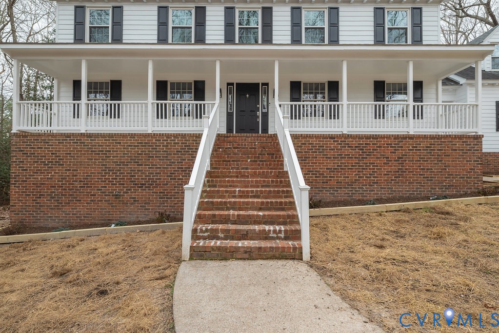 View of front of property featuring stairs and a p