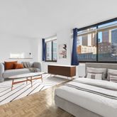 a bedroom with furniture and large windows