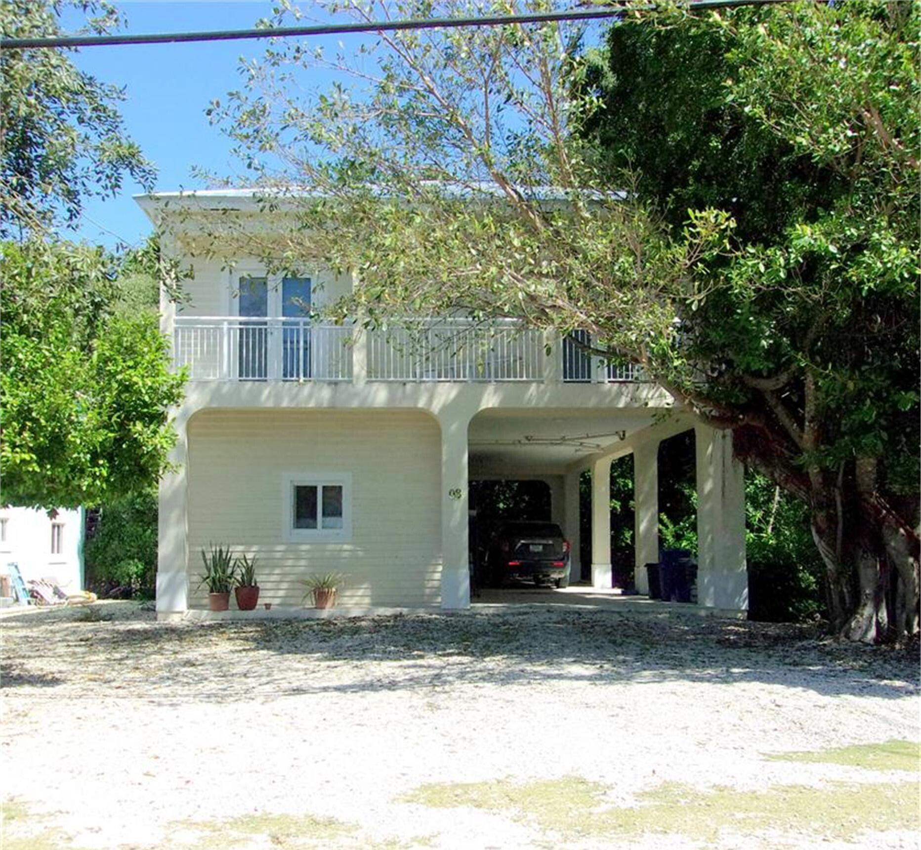 8 Bowen Drive Key Largo, FL 33037 - Photo 1 of 27 a view of a house with a yard and plants