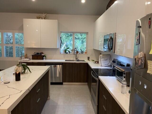 8 Bowen Drive Key Largo, FL 33037 - Photo 2 of 27 a kitchen with a sink stove top oven and refrigerator