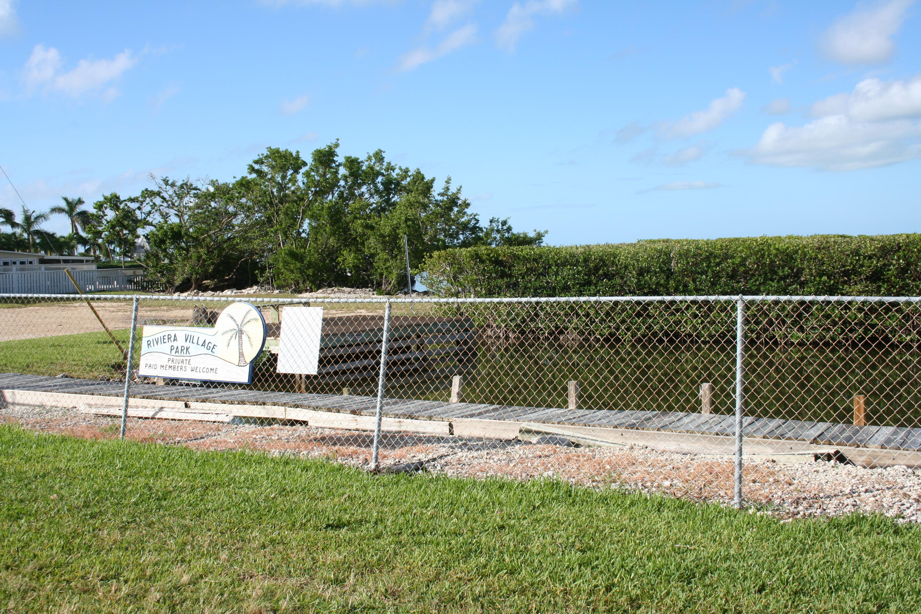 8 Bowen Drive Key Largo, FL 33037 - Photo 27 of 27 a backyard of a house with lots of green space and trampoline