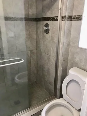 a bathroom with a glass shower door