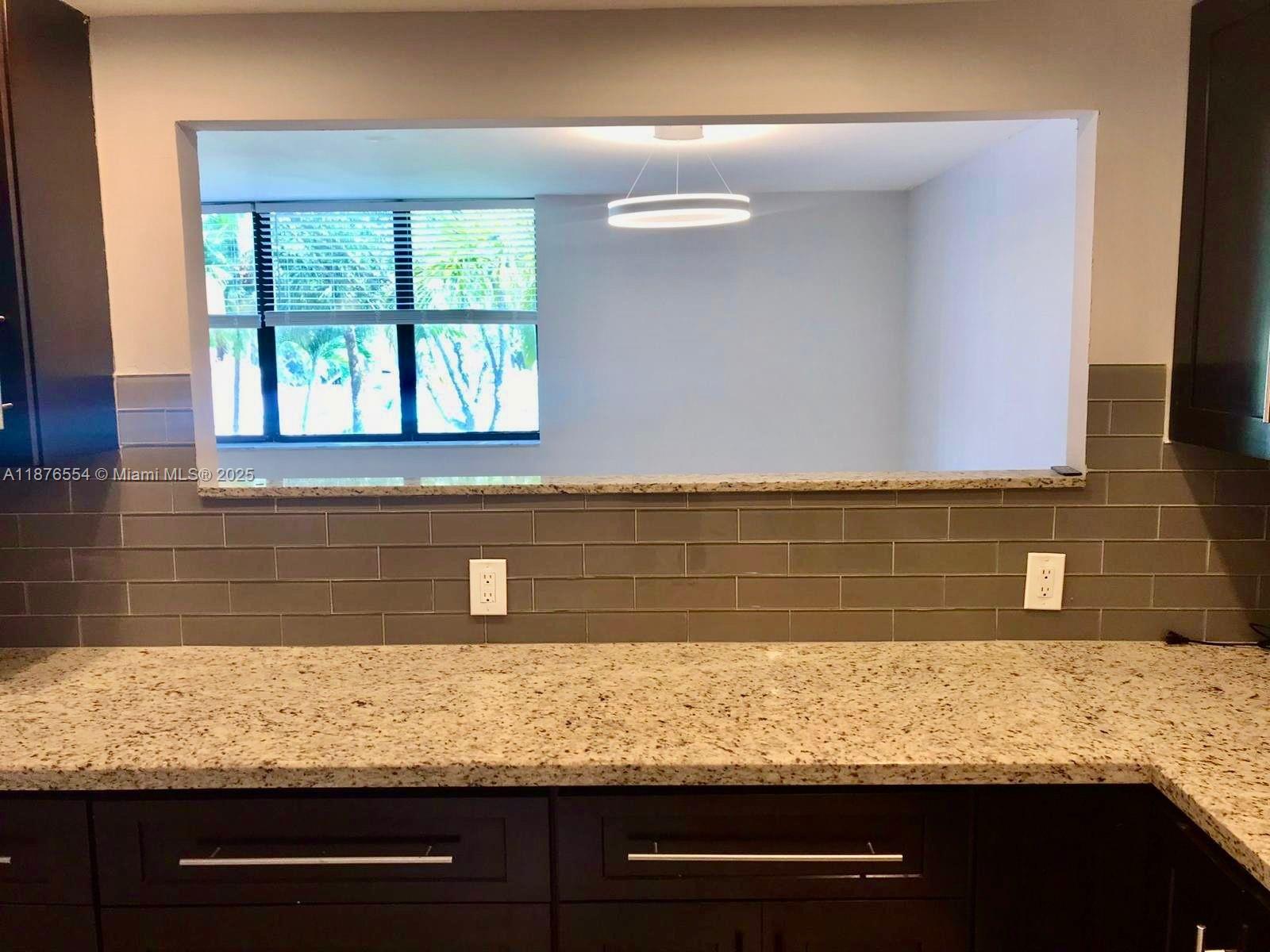 20381 Northeast 30th Avenue, Unit 2067 Aventura, FL 33180 - Photo 6 of 17 a view of bathroom with granite countertop cabinets