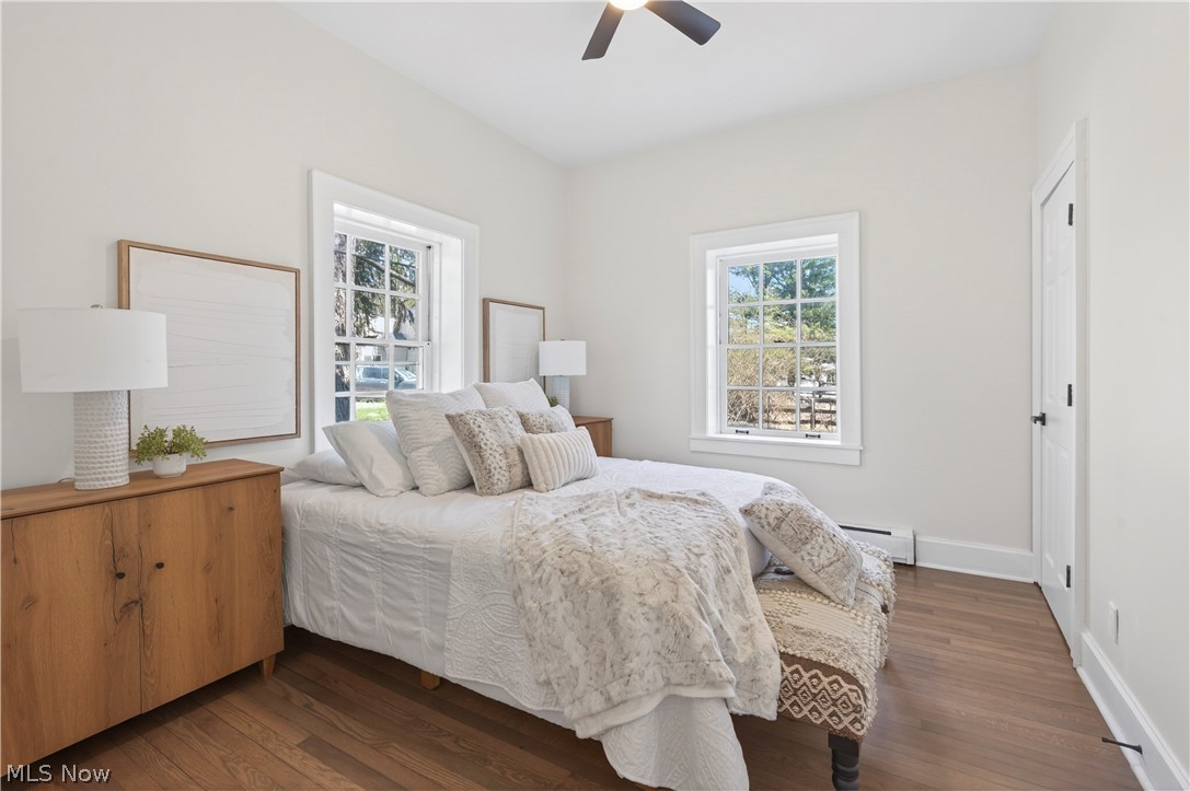 14939 Caves Road Novelty, OH 44072 - Photo 26 of 42 Bedroom with dark wood-style flooring, a baseboard heating unit, and ceiling fan