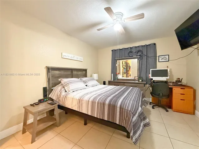 a bedroom with a bed and a television