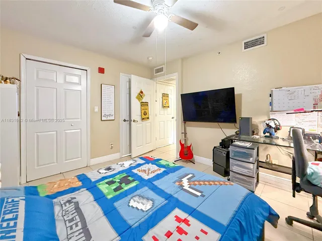 a bed room with furniture and a flat screen tv