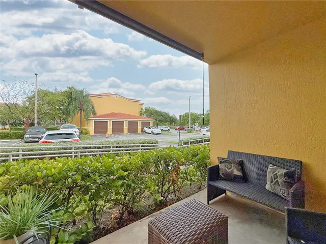 a balcony with table and chairs