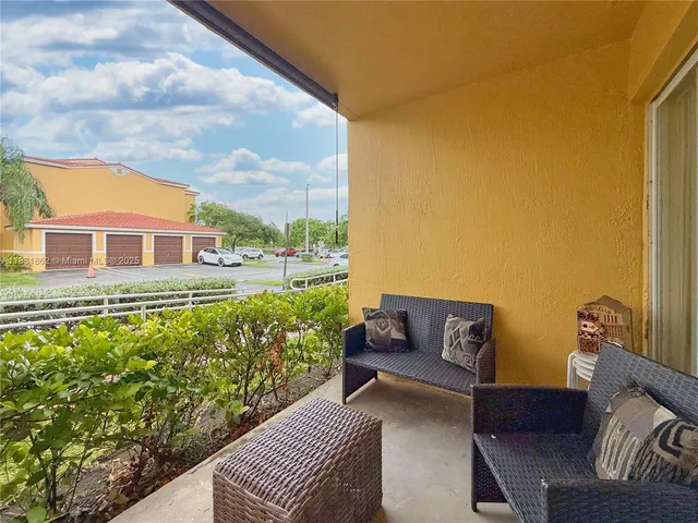 a balcony with table and chairs