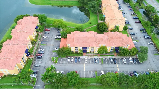 an aerial view of a house with outdoor space and a lake view in front of the house