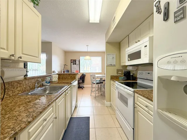 a kitchen with a sink stove and microwave