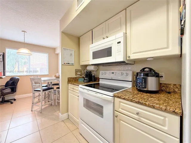 a kitchen with cabinets and appliances