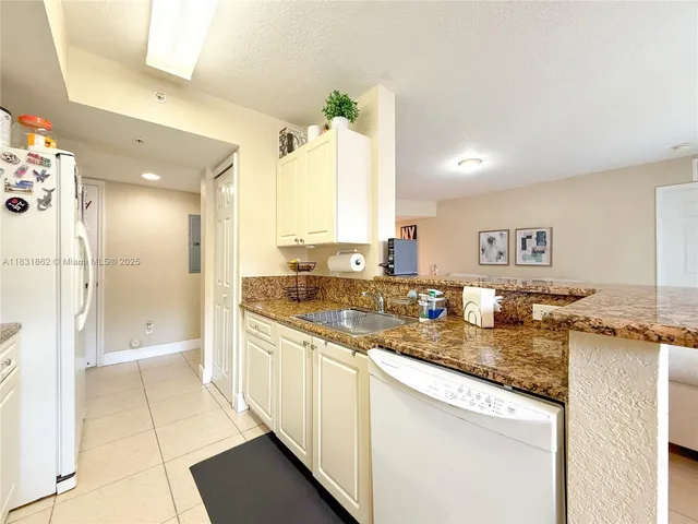 a large bathroom with a granite countertop sink and a mirror