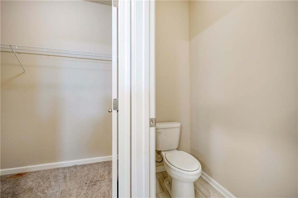 2747 Pearl Rdg Trace Buford, GA 30519 - Photo 23 of 41 a white toilet sitting next to a shower curtain