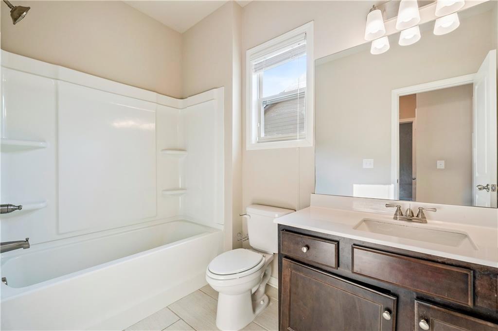2747 Pearl Rdg Trace Buford, GA 30519 - Photo 25 of 41 a bathroom with a sink a toilet a mirror and shower