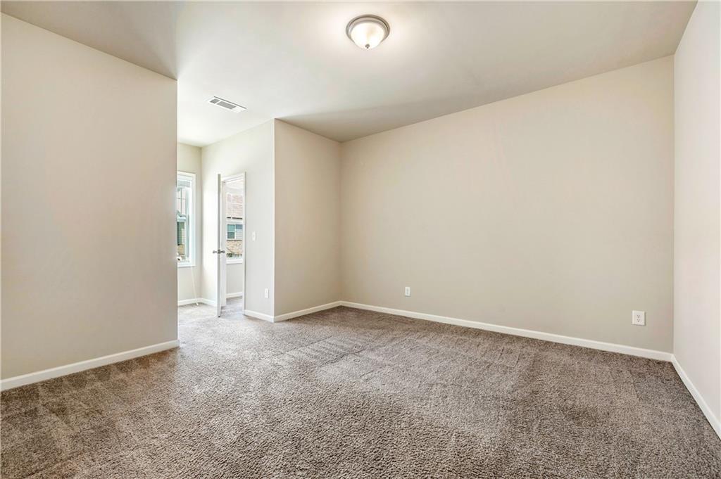 2747 Pearl Rdg Trace Buford, GA 30519 - Photo 29 of 41 an empty room with closet and a window