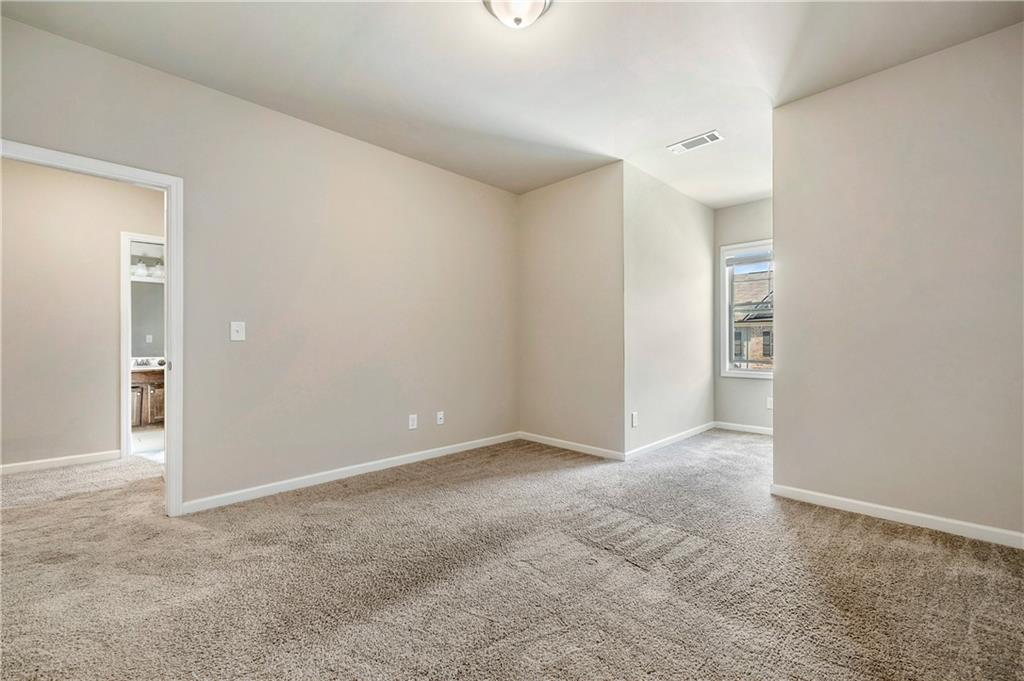 2747 Pearl Rdg Trace Buford, GA 30519 - Photo 30 of 41 an empty room with windows and entrance to other room