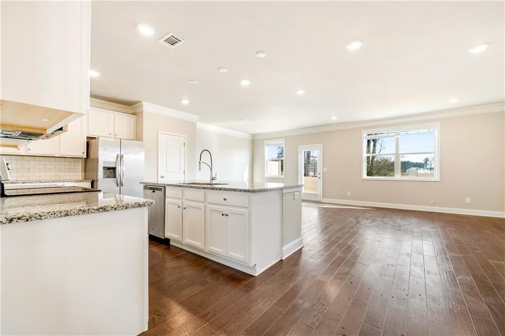 2747 Pearl Rdg Trace Buford, GA 30519 - Photo 8 of 41 a large kitchen with stainless steel appliances granite countertop a stove a sink dishwasher and a oven with white cabinets