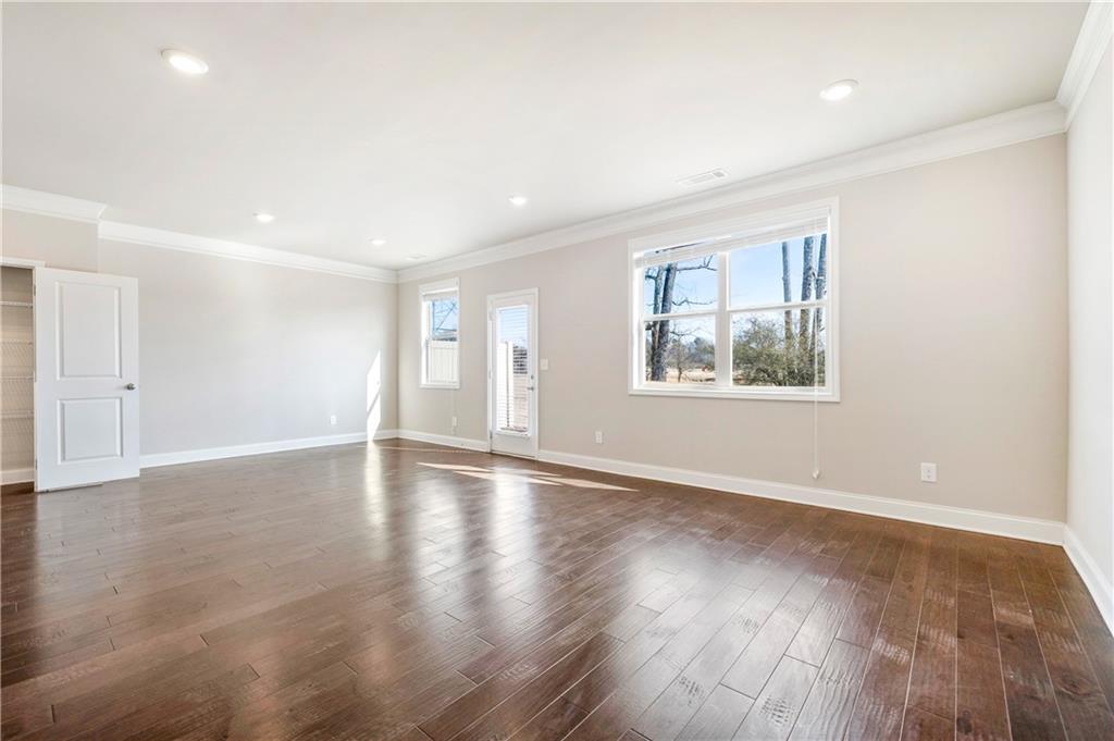 2747 Pearl Rdg Trace Buford, GA 30519 - Photo 9 of 41 a view of an empty room with wooden floor and a window