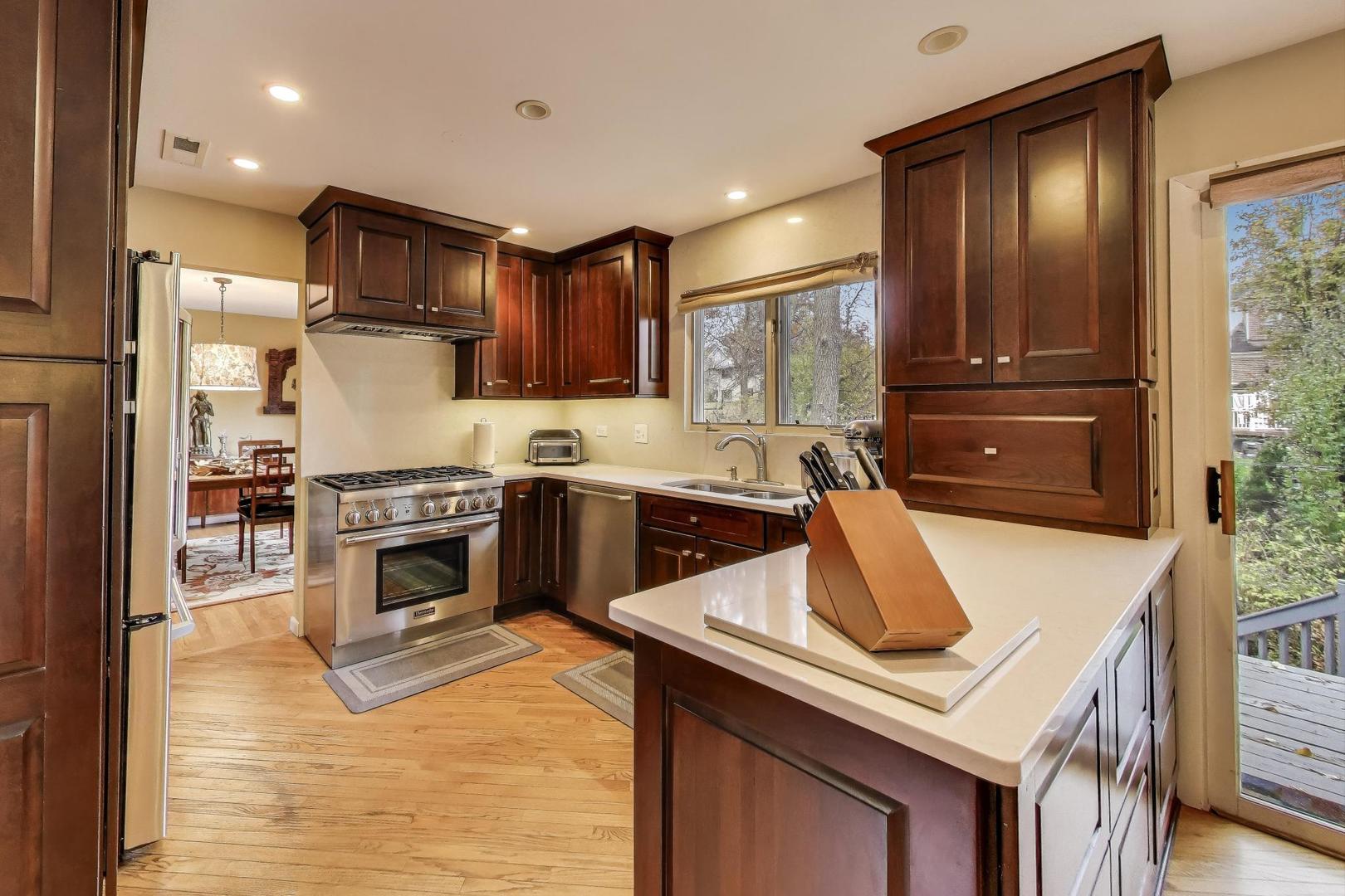 11515 Burr Oak Lane Burr Ridge, IL 60527 - Photo 12 of 73 a kitchen with a stove a sink and a refrigerator