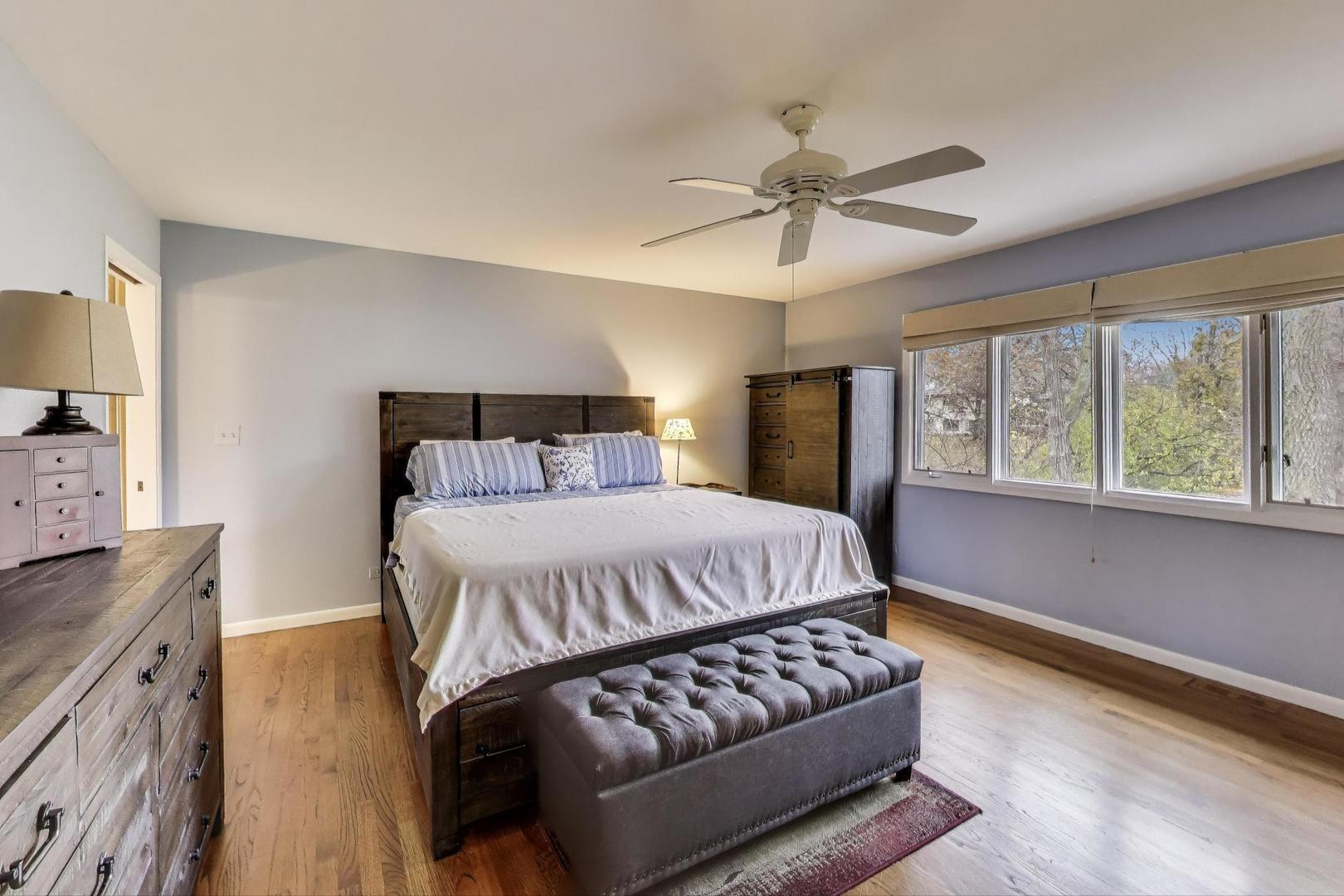11515 Burr Oak Lane Burr Ridge, IL 60527 - Photo 22 of 73 a bedroom with a bed and wooden floor