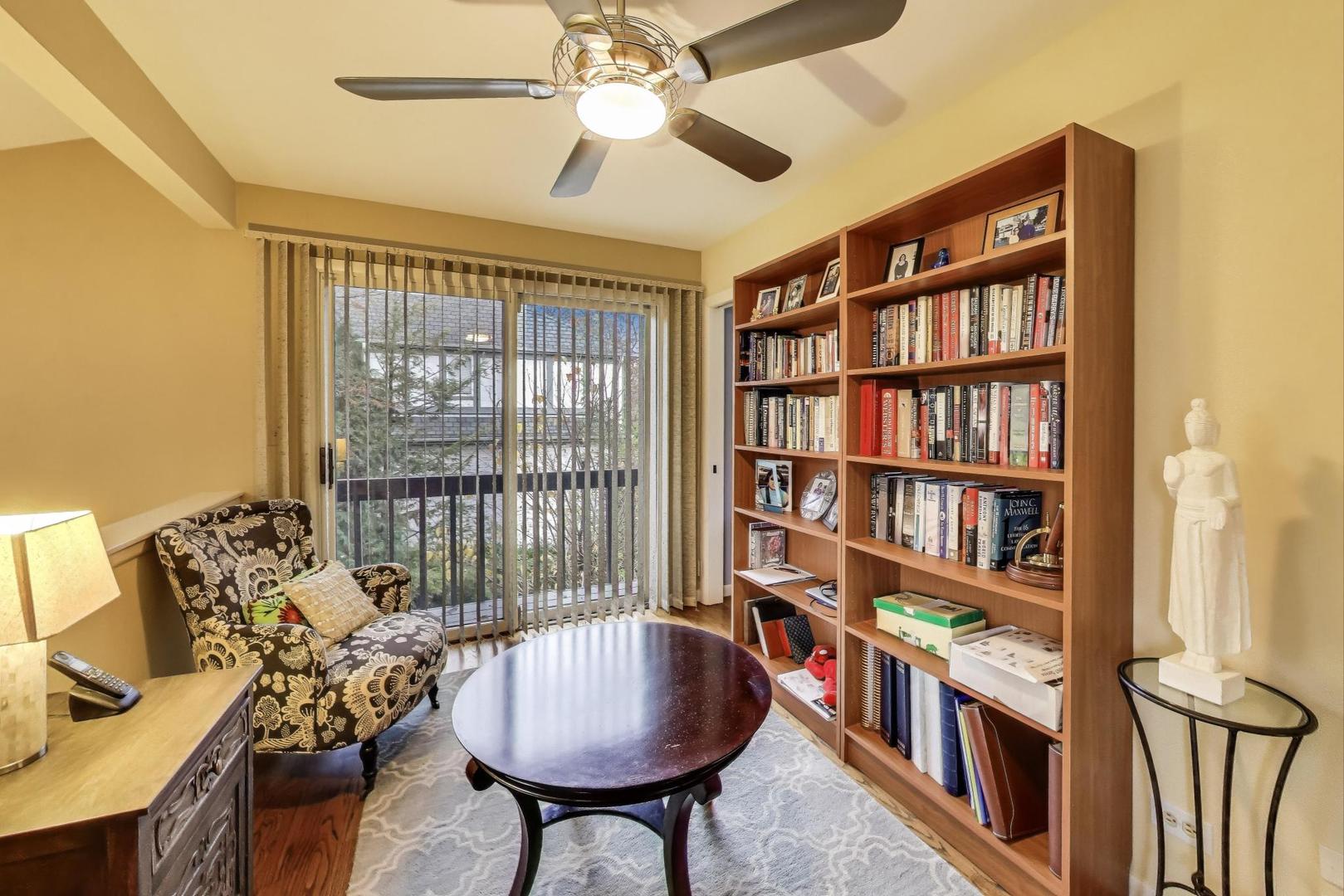 11515 Burr Oak Lane Burr Ridge, IL 60527 - Photo 28 of 73 a living room with furniture a bookshelf and a window