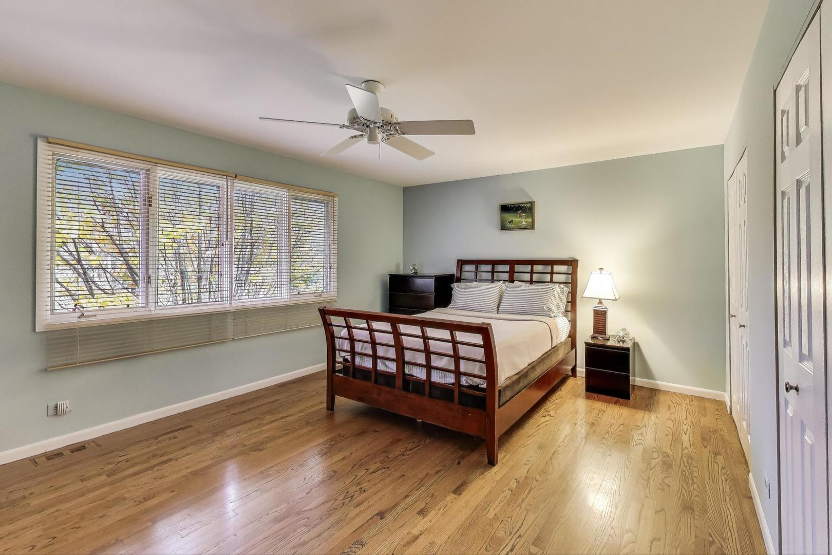 11515 Burr Oak Lane Burr Ridge, IL 60527 - Photo 31 of 73 a bedroom with a bed and wooden floor