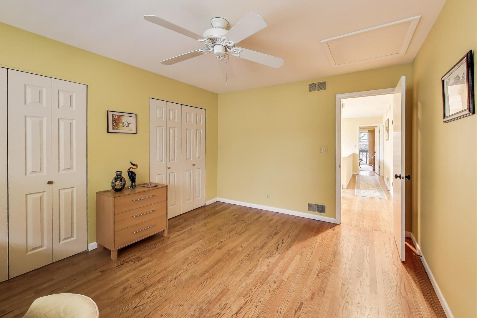 11515 Burr Oak Lane Burr Ridge, IL 60527 - Photo 34 of 73 a view of a livingroom with wooden floor and a ceiling fan