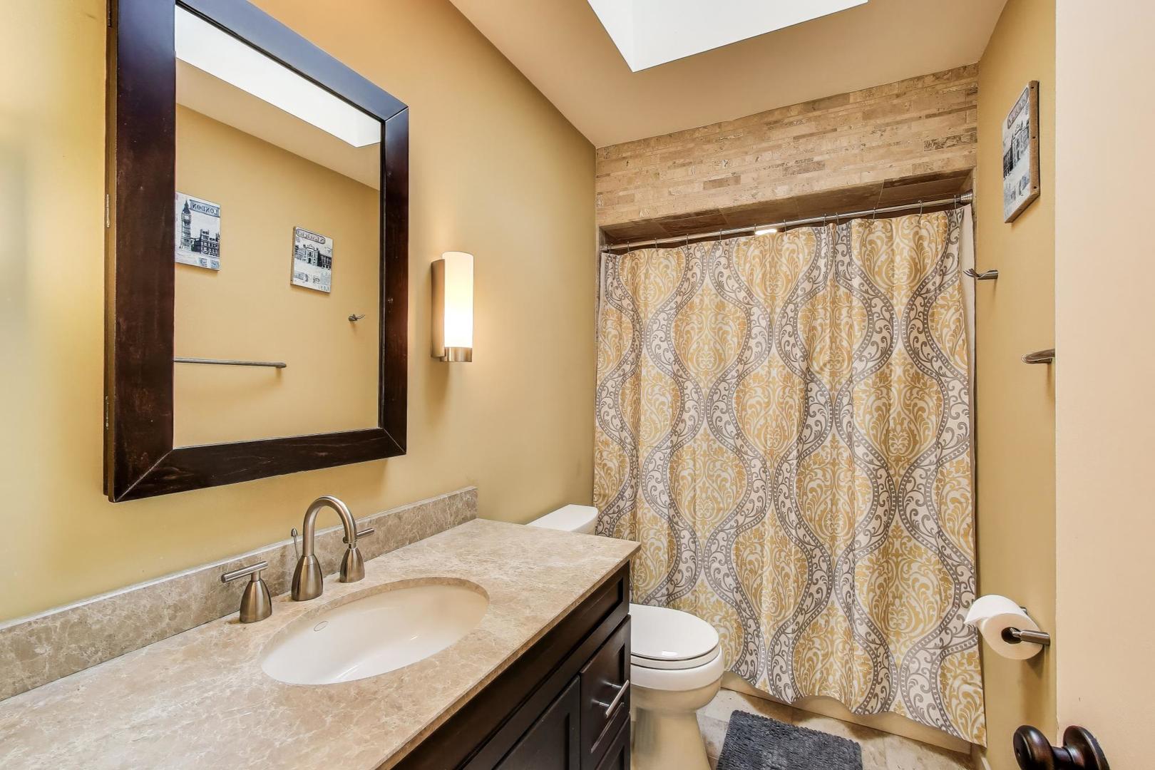 11515 Burr Oak Lane Burr Ridge, IL 60527 - Photo 35 of 73 a bathroom with a granite countertop sink and a mirror