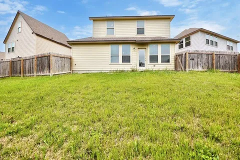 a view of a house with a backyard
