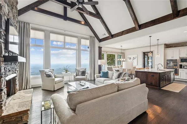 a kitchen with stainless steel appliances granite countertop a sink a stove and a wooden floors