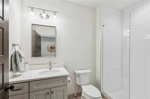 a view of a living room with furniture and floor to ceiling window