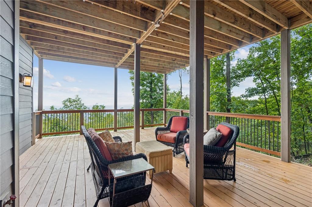 1455 Ridgeview Drive Big Canoe, GA 30143 - Photo 59 of 97 a view of a patio with couches chairs and wooden floor
