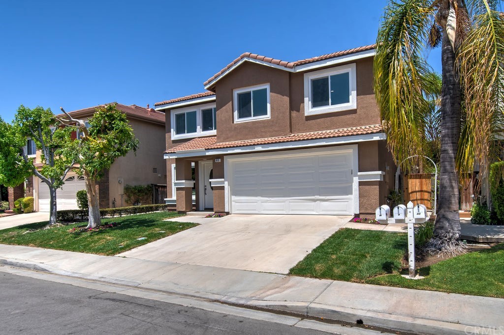 83 Linhaven Irvine, CA 92602 - Photo 1 of 1 a front view of a house with a yard and garage