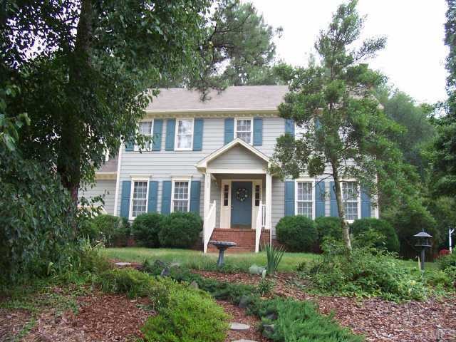 2108 Fountain Ridge Road Chapel Hill, NC 27517 - Photo 1 of 1 a front view of a house with a yard and potted plants