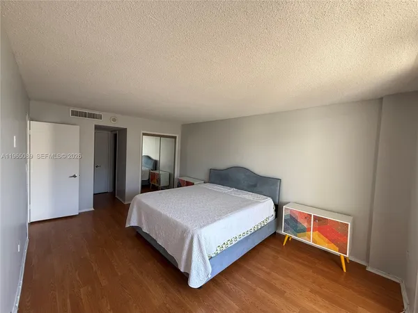 a bedroom with a bed and closet