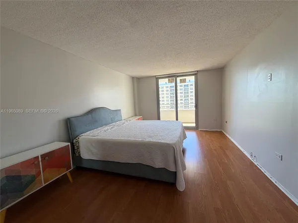 a spacious bedroom with a bed and a window