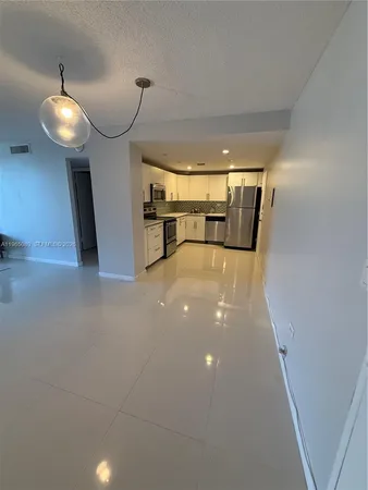 a view of a hallway with a chandelier